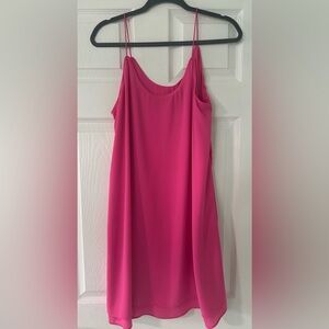 Bright and bold, the Francesca’s Ayla hot pink slip dress, party-ready piece